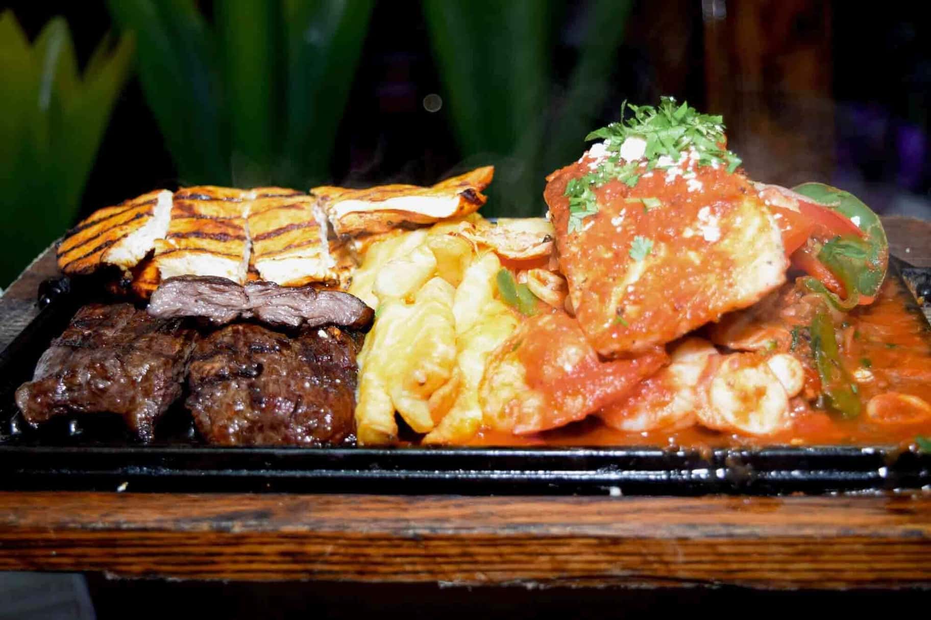 Sizzling mixed grill parrillada platter at La Herradura