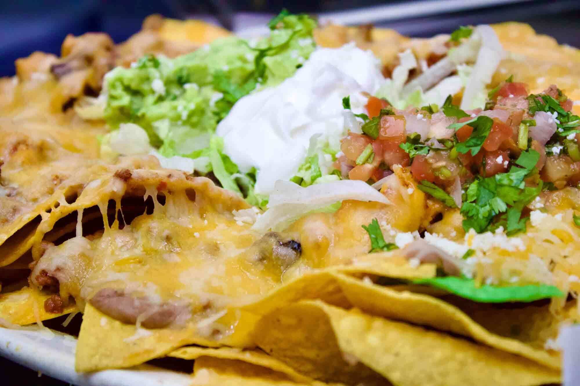 Herradura appetizers spread with nachos, guacamole and queso