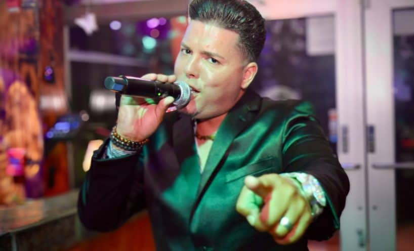 Live singer performing with microphone at La Herradura